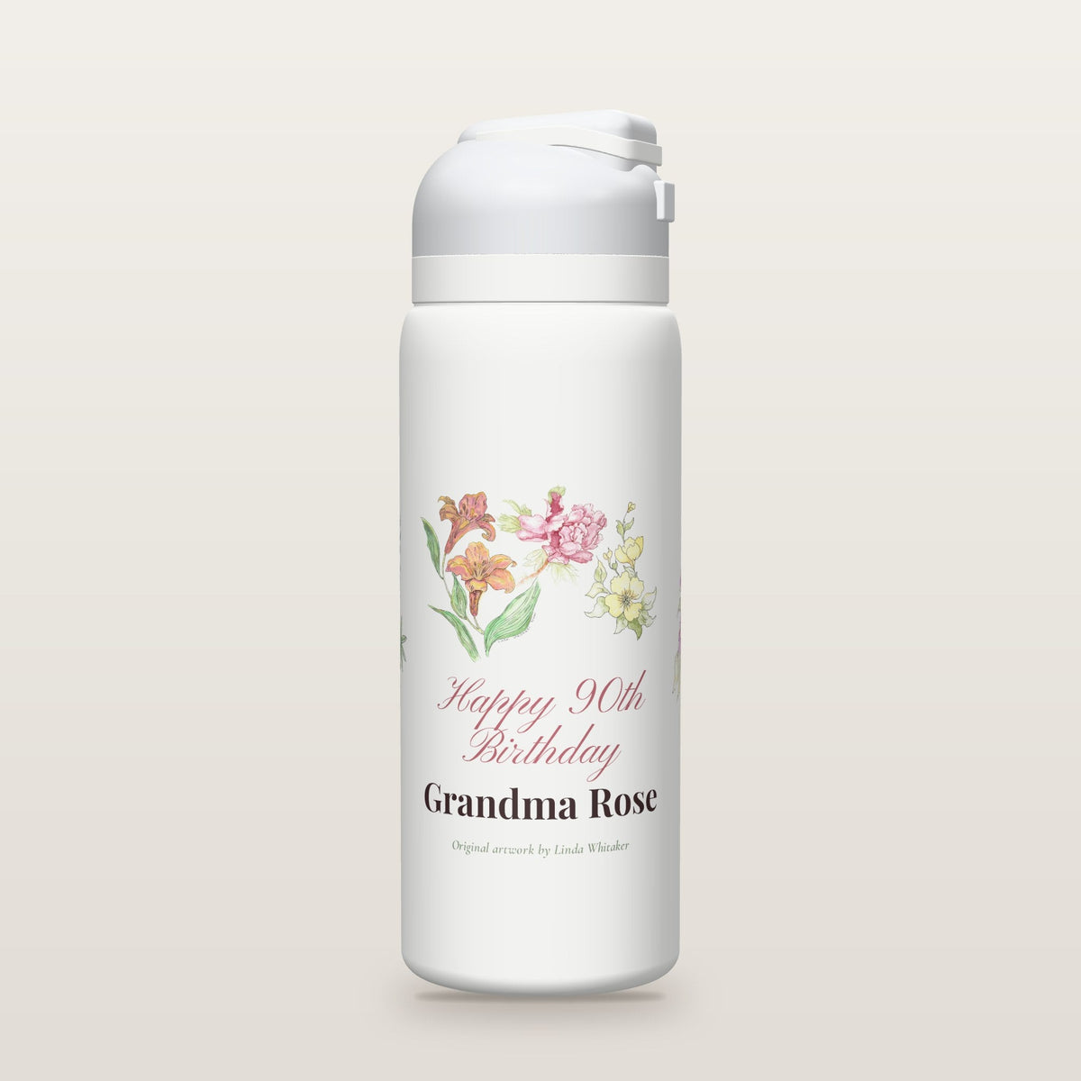 White Owala water bottle printed with watercolor lilies, a peony, yellow blossoms, purple asters and bluebonnets by Linda Whitaker, with Happy 90th Birthday Grandma Rose as a sample name and age.