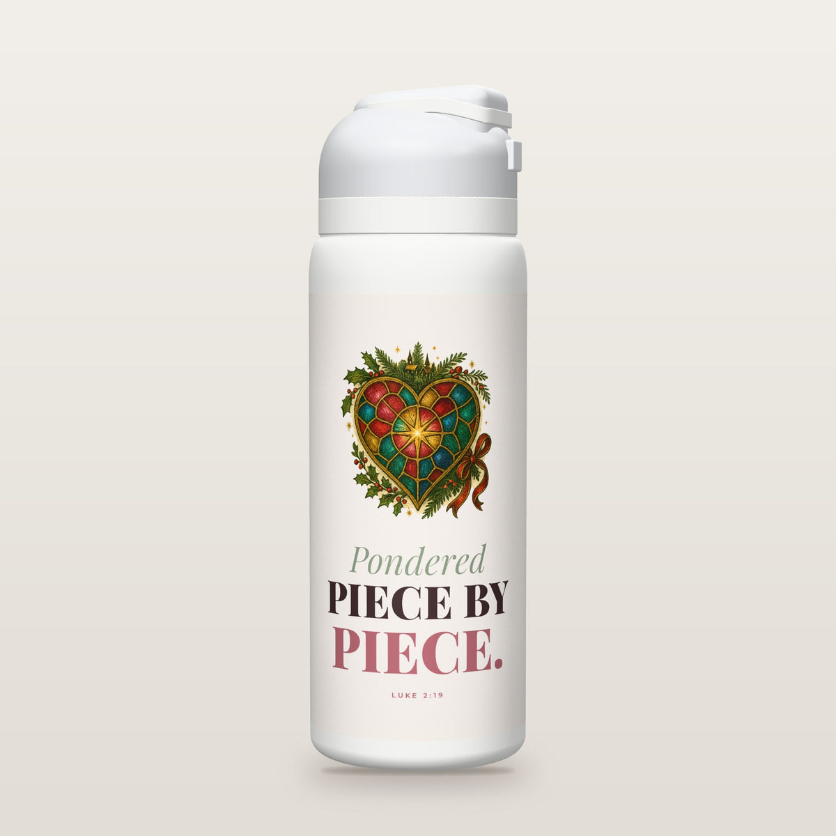 White Owala water bottle with a blush printed band, a hand-painted stained-glass heart with a gold star at its center, framed by holly, and the words Pondered PIECE BY PIECE. with Luke 2:19.