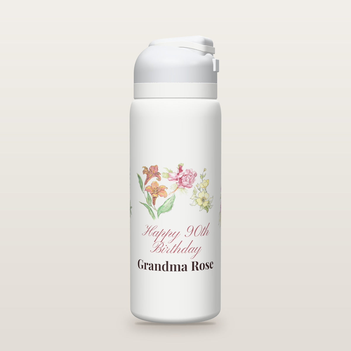 White Owala water bottle printed with watercolor lilies, a peony, yellow blossoms, purple asters and bluebonnets by Linda Whitaker, with Happy 90th Birthday Grandma Rose as a sample name and age.