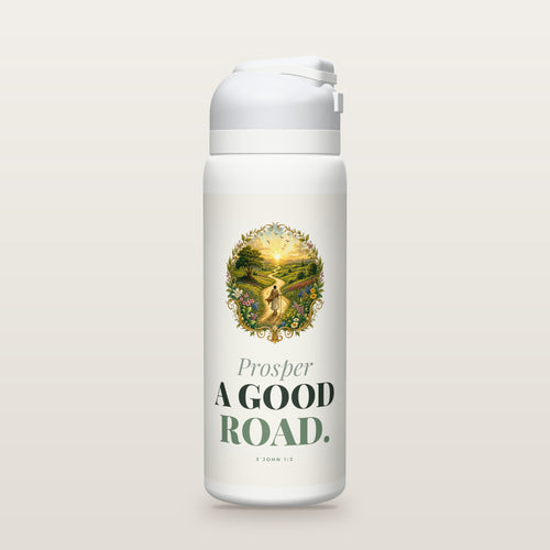 White Owala water bottle with a sage printed band, a hand-painted engraving of a traveler with a staff walking a flowering road toward the sunrise, the words Prosper A GOOD ROAD, and 3 John 1:2 with its meaning.