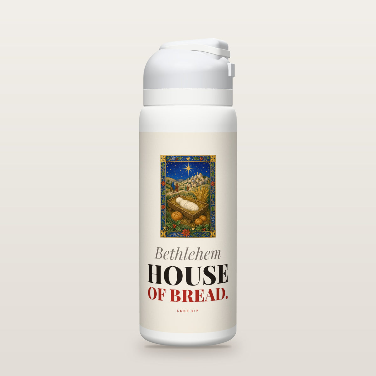 White Owala water bottle with a cream printed band, an illuminated-manuscript miniature of the baby in a feeding-trough manger beside loaves of bread and wheat, with Bethlehem beyond, and the words Bethlehem HOUSE OF BREAD. with Luke 2:7.