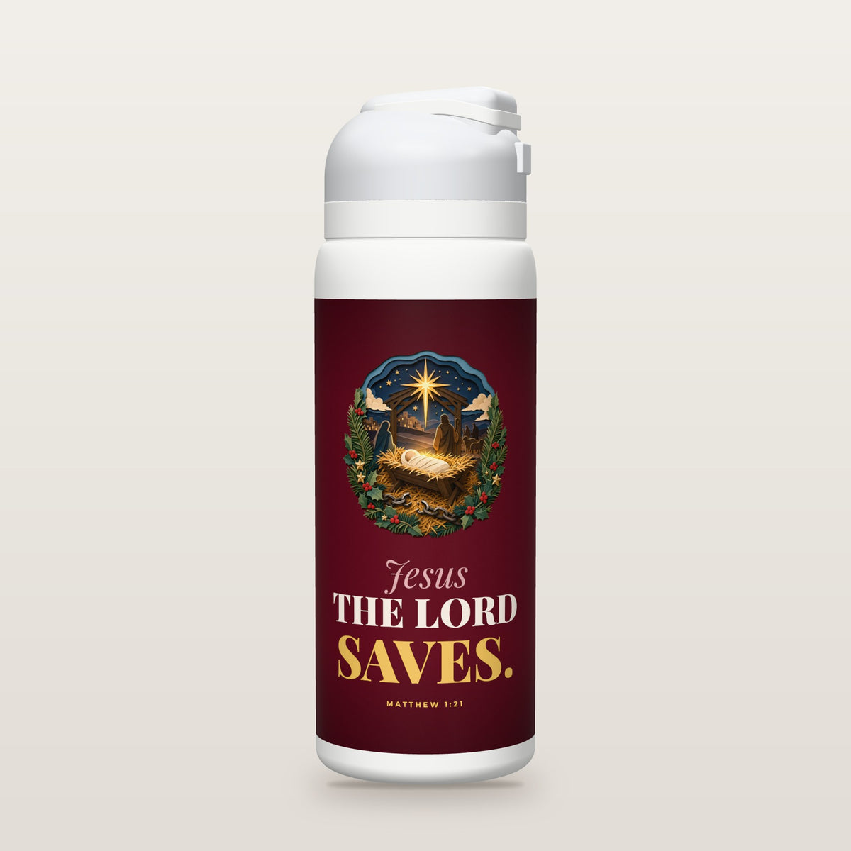 White Owala water bottle with a cranberry printed band, a layered cut-paper illustration of the baby in a glowing manger with broken chains in the straw beneath the star, and the words Jesus THE LORD SAVES. with Matthew 1:21.