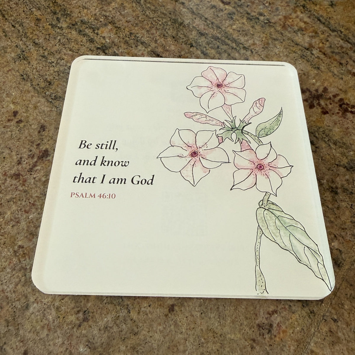 Photo of the printed Psalm 46:10 coaster on a granite countertop