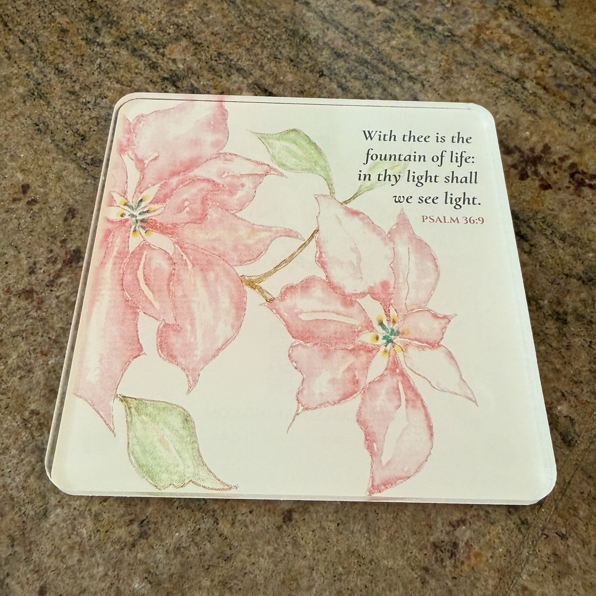 Photo of the printed Psalm 36:9 coaster on a granite countertop