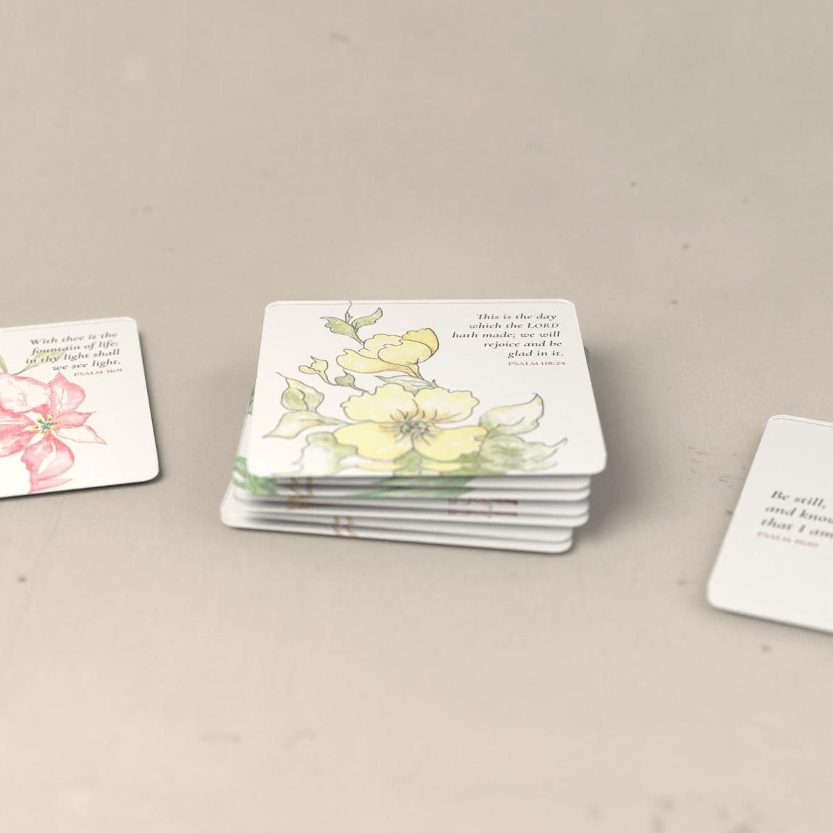 A stack of the Rejoice & Give Thanks coasters with two more coasters beside it