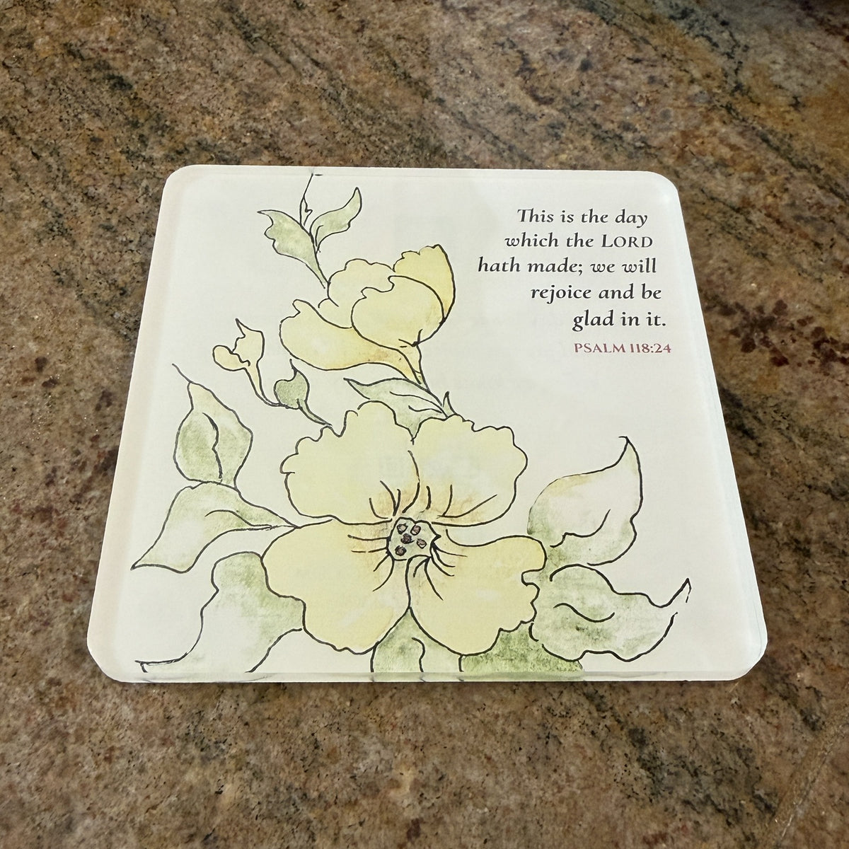Photo of the printed Psalm 118:24 coaster on a granite countertop