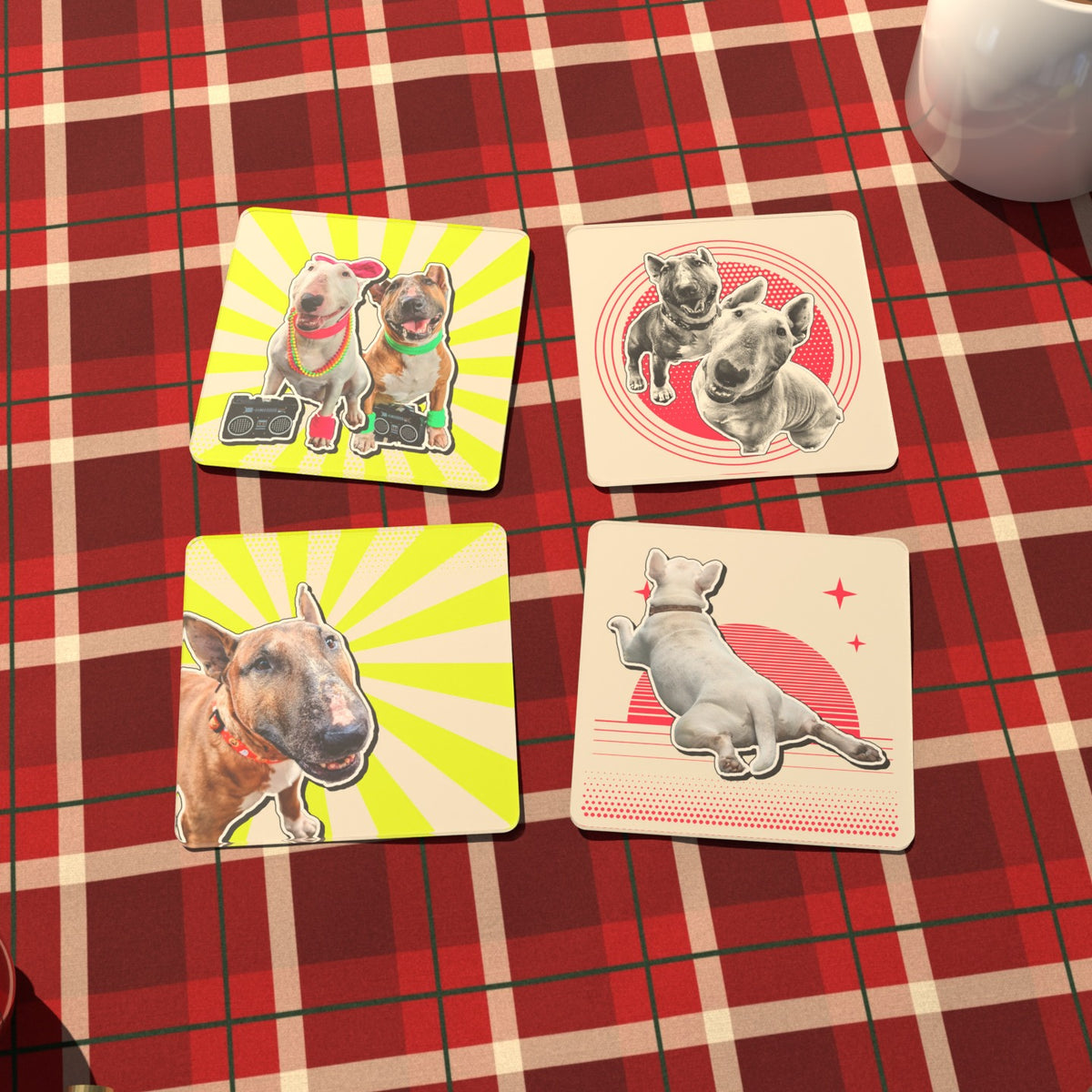 The pet coaster set on a red plaid blanket with a mug of cocoa, ornaments and a tennis ball