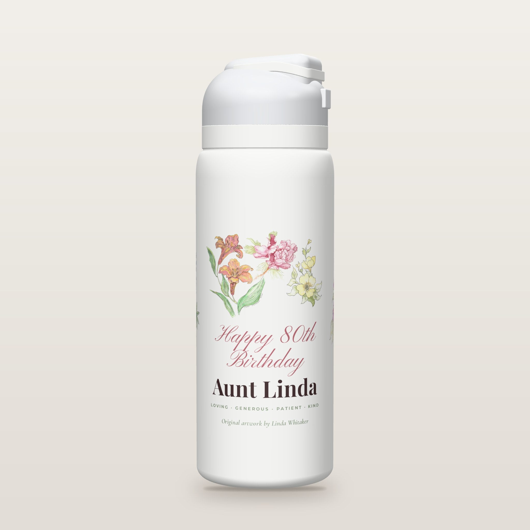 White Owala water bottle printed with watercolor lilies, a peony, yellow blossoms, purple asters and bluebonnets by Linda Whitaker, with Happy 80th Birthday Aunt Linda.
